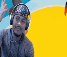 a man wearing headphones and a bandana that says u. on it