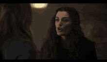 two women with long hair are talking to each other