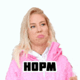 a woman wearing a pink jacket has a sticker on her jacket that says hopm