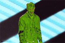 a man is covered in green slime and the words dirty delight are on the bottom of the screen