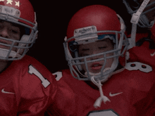 a football player wearing a helmet that says ' schutt ' on it