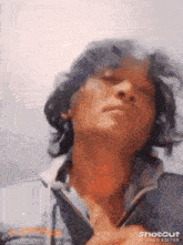 a close up of a man 's face with the sun shining through his hair