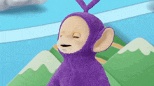 a purple teletubbies stuffed animal is sitting on a green carpet