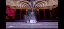 two men are dancing on a stage with the words star academy written on the bottom