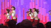 a group of women singing into microphones on a stage with a mbc logo in the corner