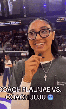 a woman wearing glasses and a necklace with the words coach flau ' jae vs. coach juju on the bottom