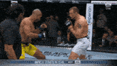 two men are fighting in a boxing ring with a sign that says experian in the background