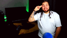 a man with dreadlocks and a tattoo on his arm is wearing a white t-shirt that says adidas