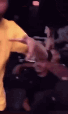 a blurry picture of a person holding a cell phone in their hand .