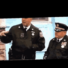 two police officers are standing next to each other with one wearing a badge that says ' nypd '