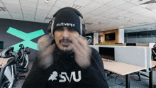 a man wearing headphones and a beanie with the word multiverse on it