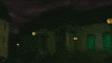 a blurry picture of a building with purple clouds in the background .