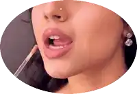 a close up of a woman 's mouth with a brush in it