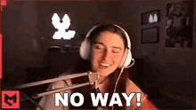 a woman wearing headphones is sitting in front of a microphone and saying `` no way ! ''
