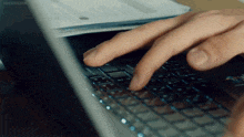 a close up of a person typing on a laptop with kissasian written on the bottom right
