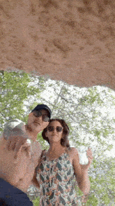 a man and a woman are posing for a picture and the woman is holding a bottle of water