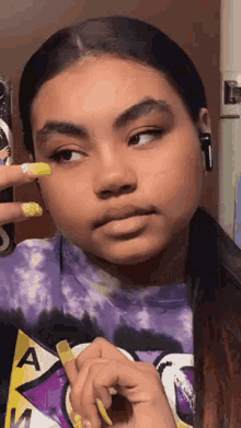 a young girl is taking a selfie with her phone .