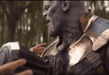 a close up of a person holding a hammer next to a man in a suit .