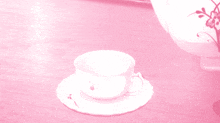a cup of tea is being poured into a saucer next to a teapot