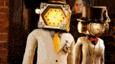 a man with a clock on his head and a woman with a clock on her head