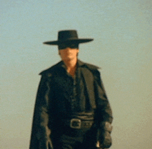 a man wearing a black hat and a mask