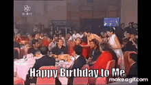 a group of people sitting at tables with the words happy birthday to me written on the screen