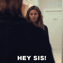 a woman is standing in front of a door that says ph3