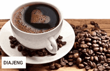 a cup of coffee sits on a saucer next to a pile of coffee beans with the word diajeng above it
