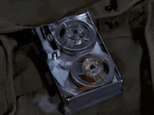a close up of a tape recorder with two reels of tape in it