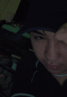 a man wearing a black hat covering his eyes