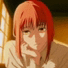 a close up of a person with red hair and a white shirt .
