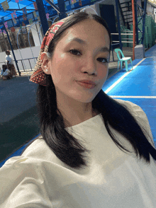 a woman wearing a headband with the letter r on it takes a selfie