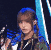 a girl wearing braids and a camouflage jacket