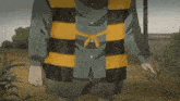 a cartoon character wearing a striped shirt and shorts is standing in a field .