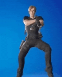 a man in a black shirt and black pants is standing on one leg .