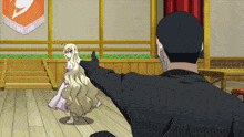 a man in a black suit is pointing at a little girl in a white dress