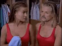 a man and a woman in red tank tops standing next to each other