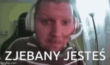 a man wearing headphones and a headset with the words zjebany jestes written on the bottom