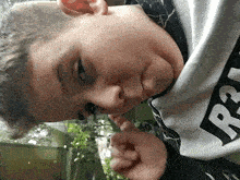 a young boy wearing a sweatshirt that says r.i.