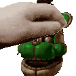 a pixel art of a hand holding a teddy bear 's mouth open with a hamburger in it .