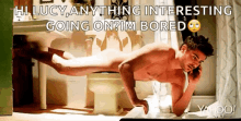 a naked man is talking on a cell phone while doing push ups in a bathroom .