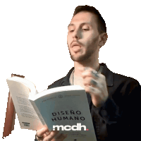 a man reading a book called diseno humano