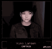 a woman wearing a hat and headphones is giving the middle finger