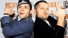 two men are posing for a picture and making funny faces .