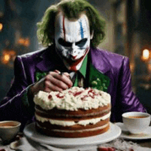 a man dressed as the joker is eating a cake .
