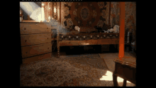 a person laying on a bed with a rug behind them