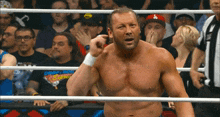 a wrestler in a ring with a la hat on