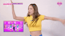 a girl in a yellow t-shirt with a heart on it is dancing