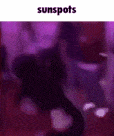 a blurry picture of a person dancing with the words sunspots written above them