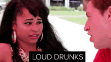 a man and a woman are looking at each other with a sign that says loud drunks above them